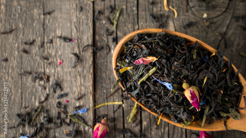 Wallpaper Mural Dry tea in wooden plates, on wooden background. Leaves of red, green and black tea. Macro photo. Torontodigital.ca