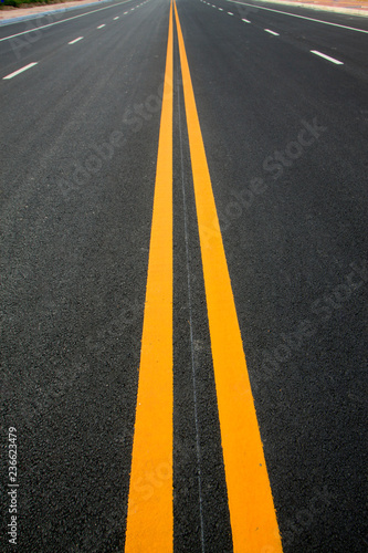 Double yellow lines on the asphalt road