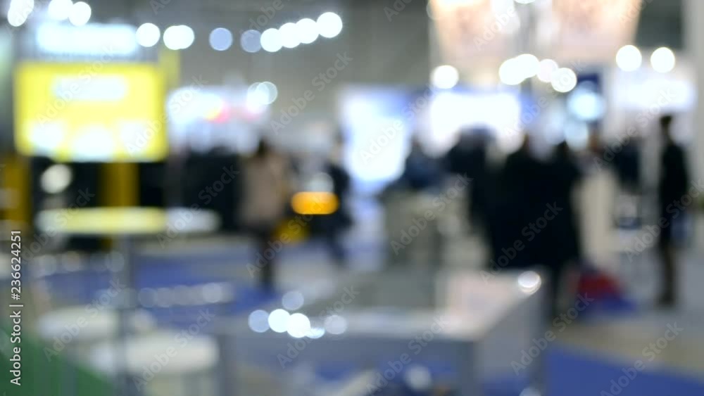 Abstract Defocused Blurred Background flow of many people inside space shopping center or mall, exhibition, exposition, hall real time. Abstract Defocused Blurred Background flow of many people inside space shopping center or mall, exhibition, exposition, hall real time.