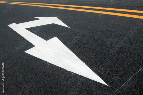 Turn down arrow on the asphalt road © zhang yongxin