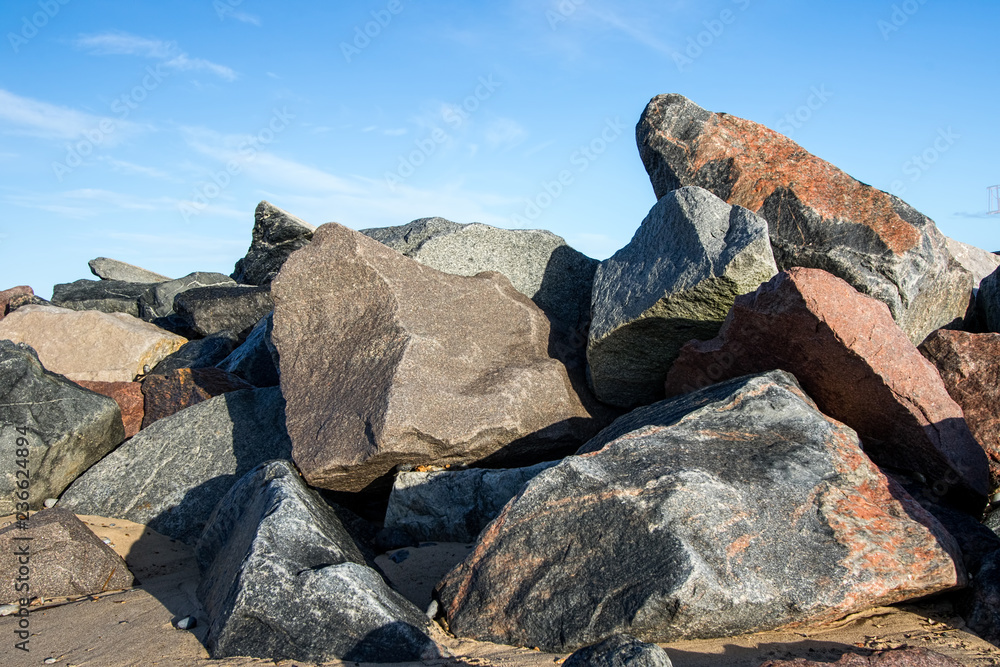 Flood Including Rocks Pile of multicolored rocks and boulders as coastal erosion beach sea ...