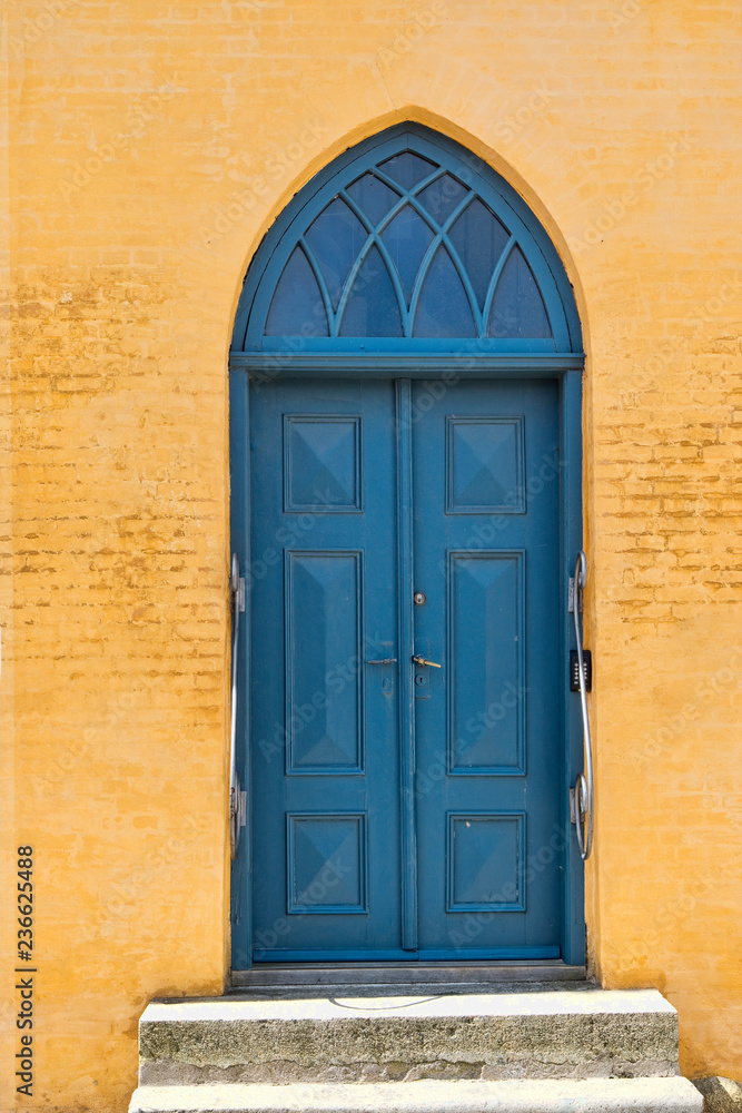 Blue Door in a Yellow Building