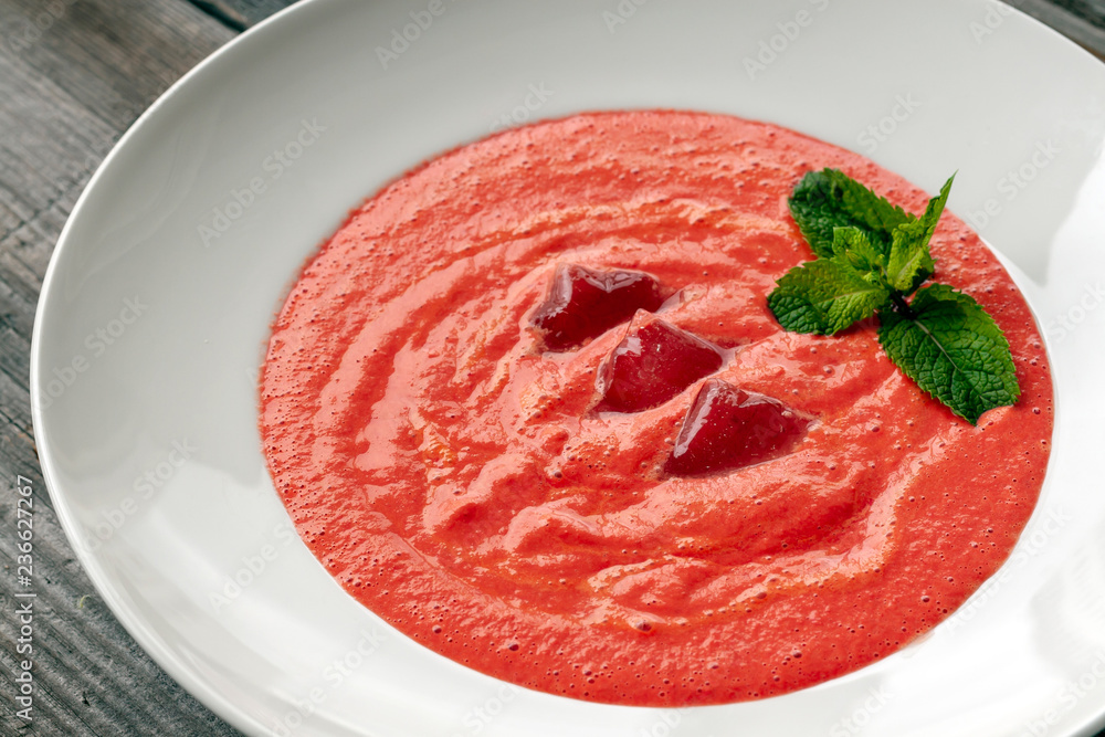 Vegetarian dish. Gazpacho soup made from tomatoes, cucumbers, pepper, lemon juice and pine nuts, decorated with basil and ice. Vegetarian dish. Gazpacho soup made from tomatoes, cucumbers, pepper, lemon juice and pine nuts, decorated with basil and ice.