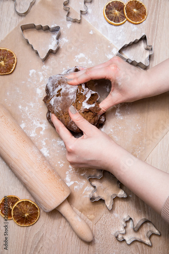 Making christmas gingerbread cookies, cookie cutting and rolling dough, baking gingerbread men.