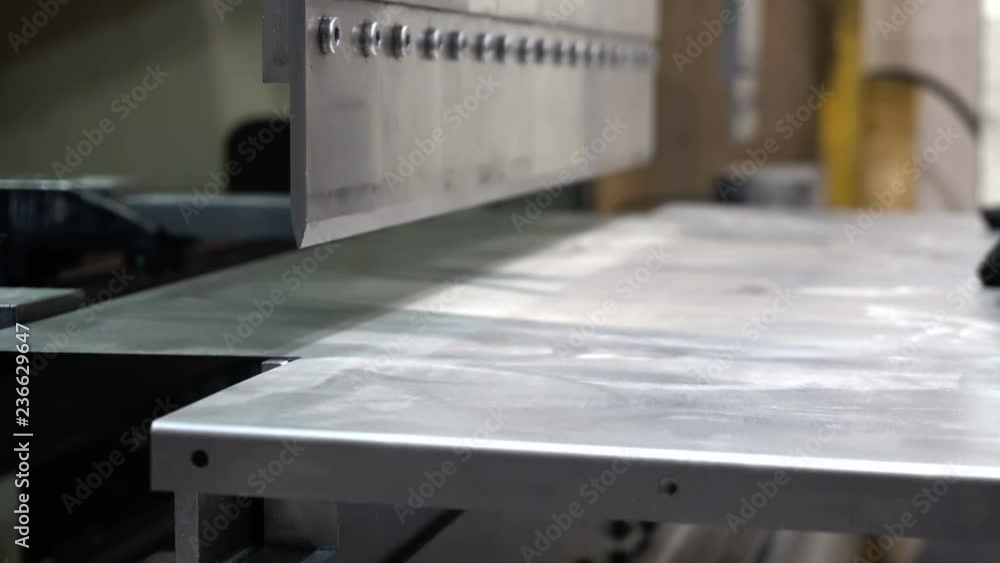 CNC bending machine. The machine bends the metal part CNC bending machine. The machine bends the metal part
