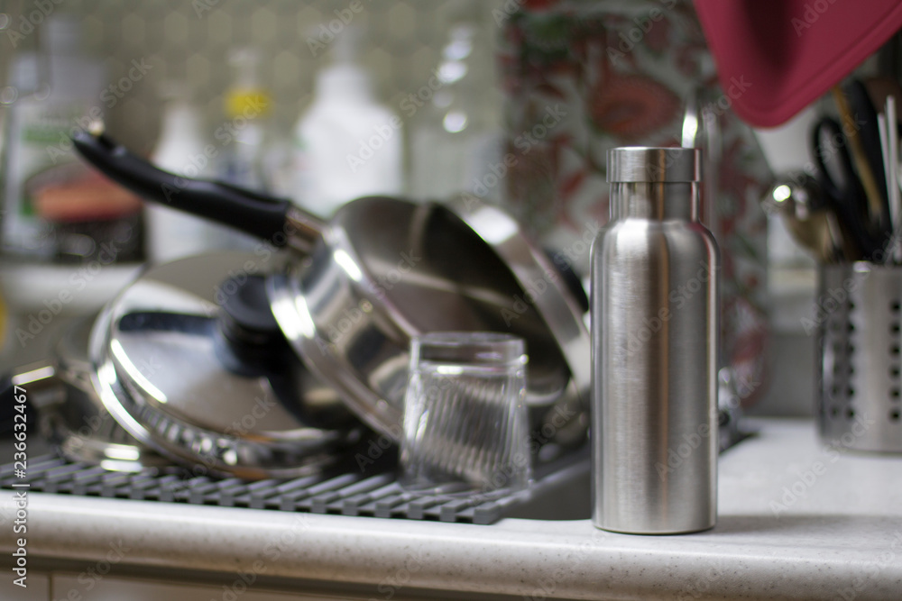 Insulated Stainless Bottle with utensils on sink kitchen Insulated Stainless Bottle with utensils on sink kitchen
