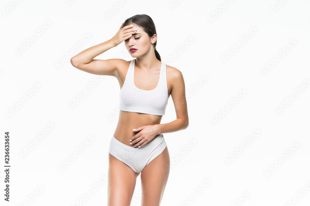 Beautiful slim woman wearing white lingerie have head pain. Studio shot of young seductive woman isolated on white background. Woman having headacke Beautiful slim woman wearing white lingerie have head pain. Studio shot of young seductive woman isolated on white background. Woman having headacke
