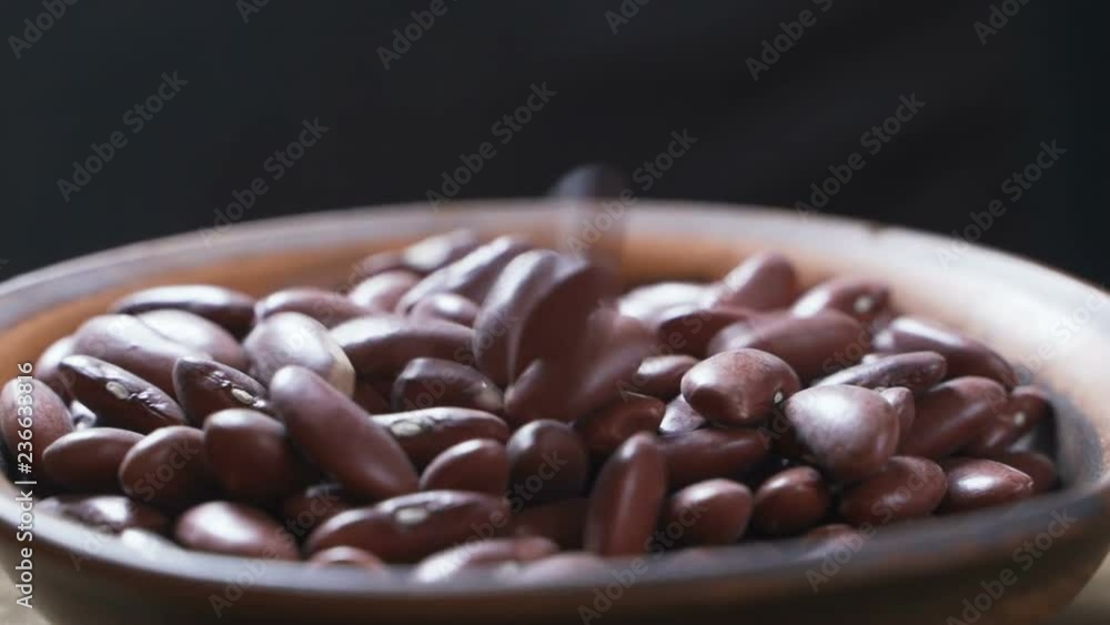 Red kidney beans pouring into bowl Red kidney beans pouring into bowl