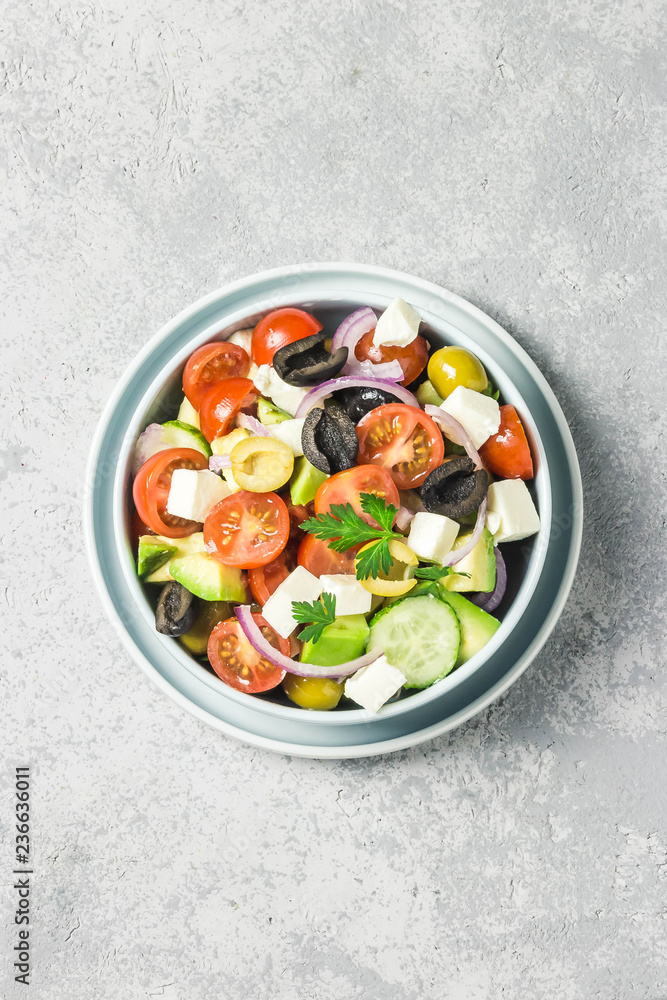 Avocado feta Greek salad in a bowl. Top view, space for text. Avocado feta Greek salad in a bowl. Top view, space for text.