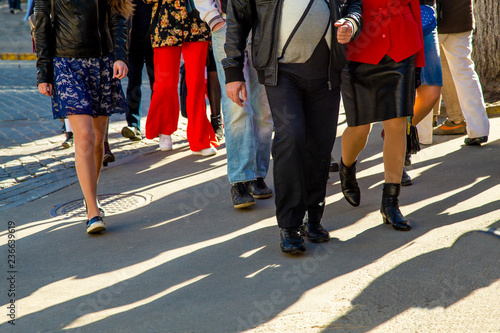many legs of People walking in the crowded streets