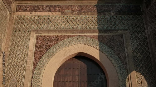 Camera tilt down view from top to bottom of Bab Mansour Gate wooden door in Meknes, Morocco photo