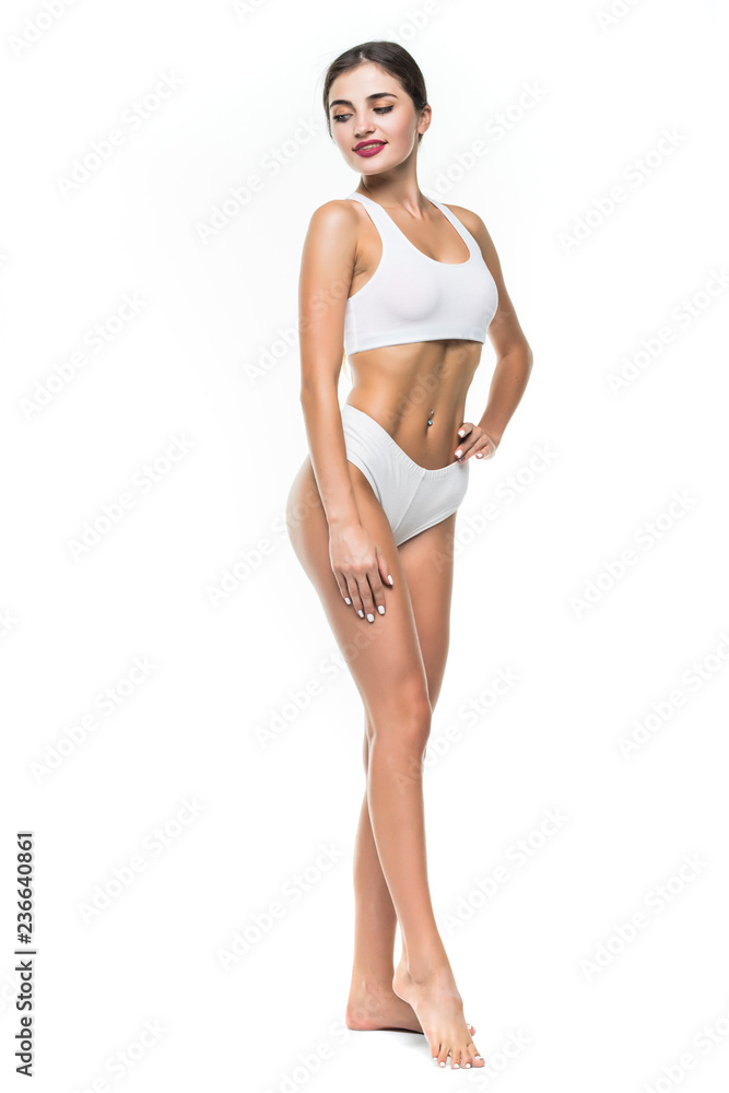 Happy young slim woman with beautiful perfect body posing on white background. Full-length portrait Happy young slim woman with beautiful perfect body posing on white background. Full-length portrait