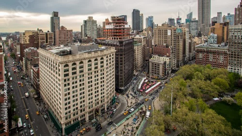 Birds eye view of pedestrians and cars during rush hour in Manhattan's Flatiron District in New York City, New York.