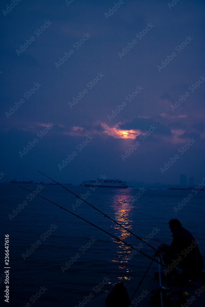 Sunset and fisherman