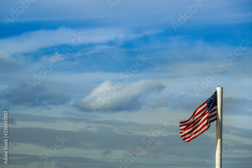American flag blue sky background. Free space for text.