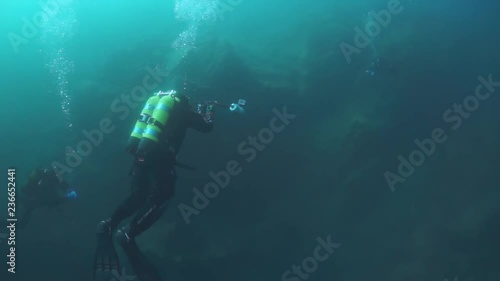 Wallpaper Mural Scuba diver cameramen with group swimming deep underwater in Lake Baikal. Torontodigital.ca