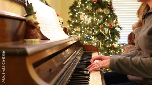 Woman Playing Piano at Christmas