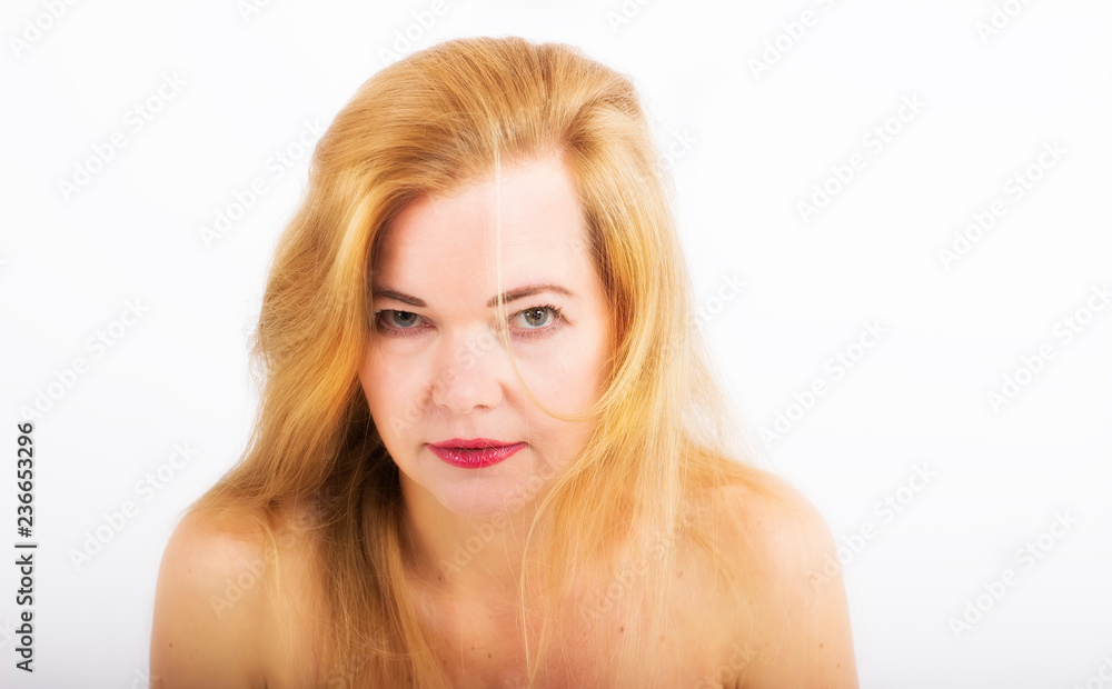 Beautiful middle aged woman looking straight at the camera.Portrait close up on white background Beautiful middle aged woman looking straight at the camera.Portrait close up on white background