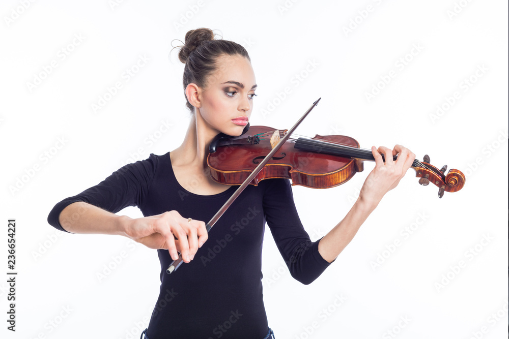 Beautiful young woman playing violin, studio shot