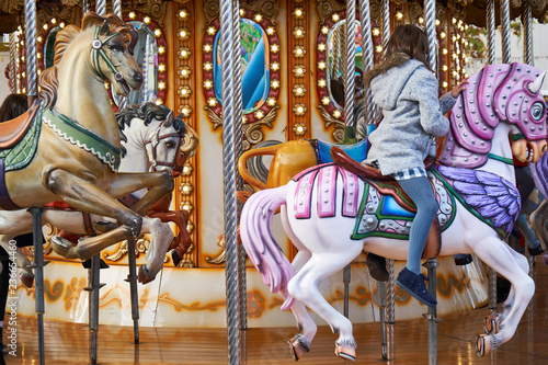 little girls back on a carousel