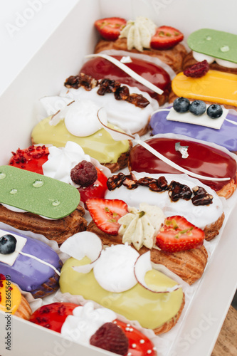 Set of delicious eclairs with glaze, colorful dessert