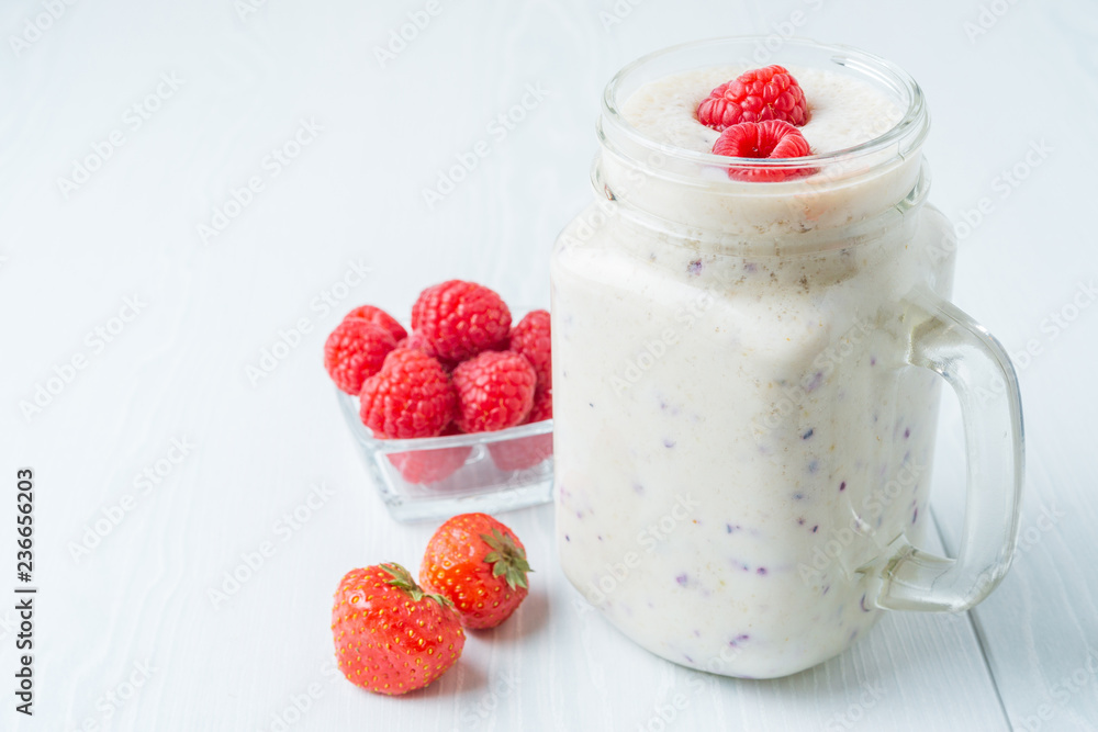 Raspberry and strawberry smoothies on a light background