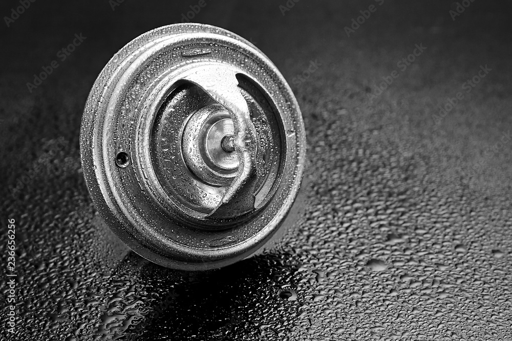 Thermostat engine cooling system of the internal combustion machine. Spare parts on a dark background