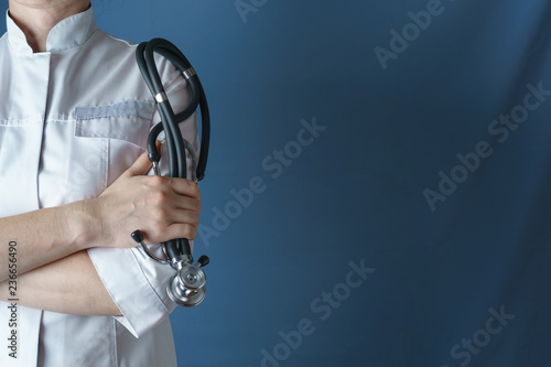 Photography Doctor in white coat with a stethoscope standing with arms folded, closeup
