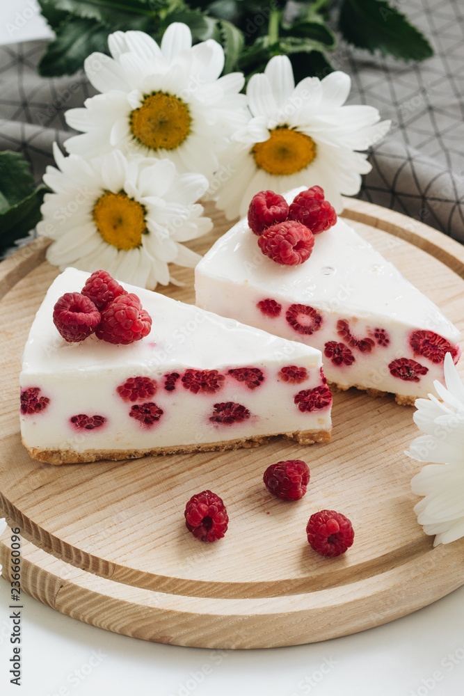 Two pieces of delicious cake with raspberries, sweet dessert Two pieces of delicious cake with raspberries, sweet dessert