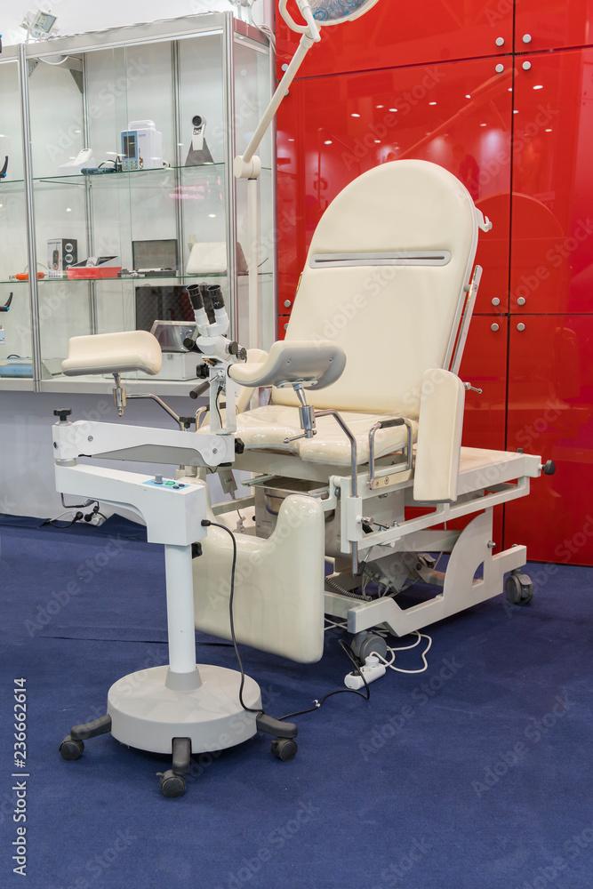 gynecological chair and other medical equipment in a gynecological office. vertical photo