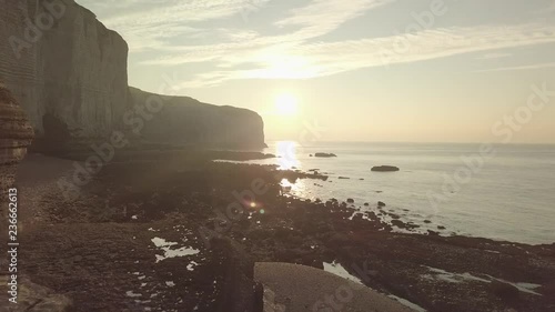 Flying drone sunset inside amazing natural rock arch in France