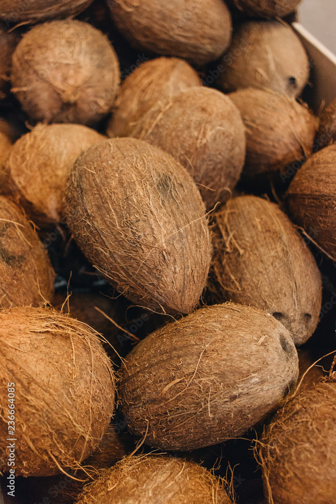 Pile of coconuts, tropical fruits background