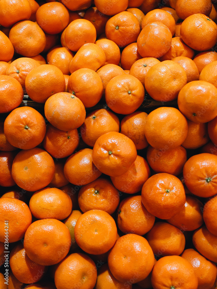 Pile of fresh mandarins, food background