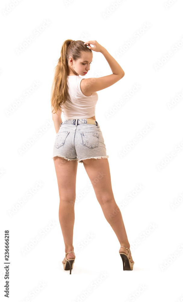 Beautiful girl in shorts and top posing in the Studio. Beautiful girl in shorts and top posing in the Studio.