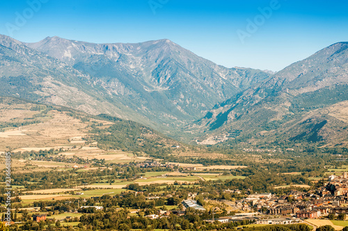 Scenic aerial view of the Mountain valley in the Pyrenees, with agricultural fields, villages and the city of Puigcerda