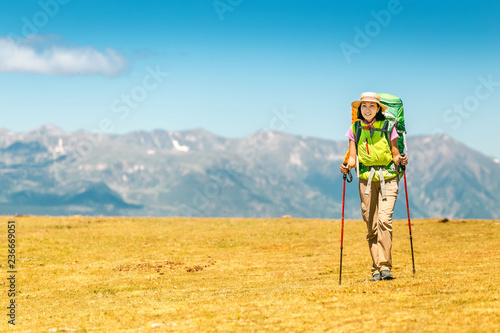 Wallpaper Mural Happy woman walking with backpack in Pyrenees mountains Highlands Torontodigital.ca