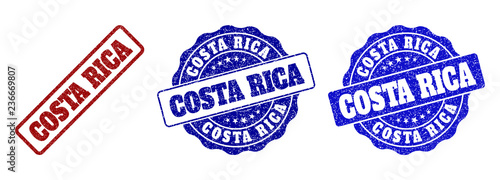 COSTA RICA scratched stamp seals in red and blue colors. Vector COSTA RICA labels with grainy surface. Graphic elements are rounded rectangles, rosettes, circles and text labels.