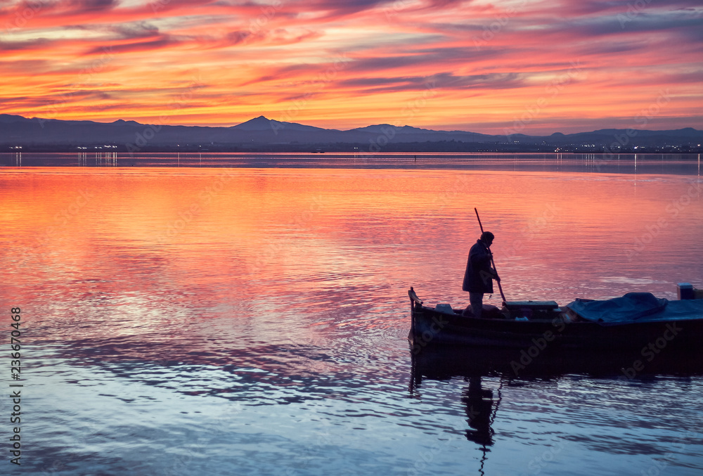 Boat ride in the Sunset of the calm waters of the Albufera de Valencia, Spain.