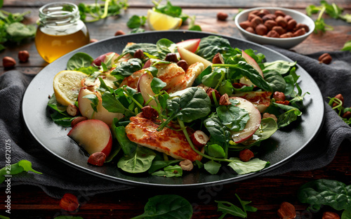 Grilled Halloumi Cheese salad with peach fruit, nuts and spinach, arugula mix. healthy food