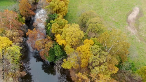 Aerial pan, vibrant Autumn trees following Cocalico Creek near Brownstown, Lancaster, PA, USA. photo