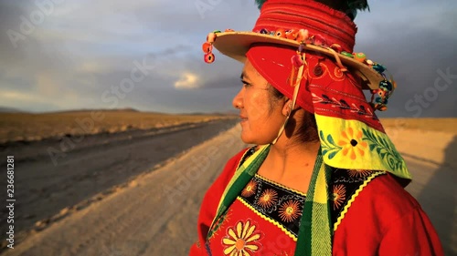 Portrait of Bolivian female on Salar de Uyuni in traditional National dress proudly smiling in South America Wilderness 