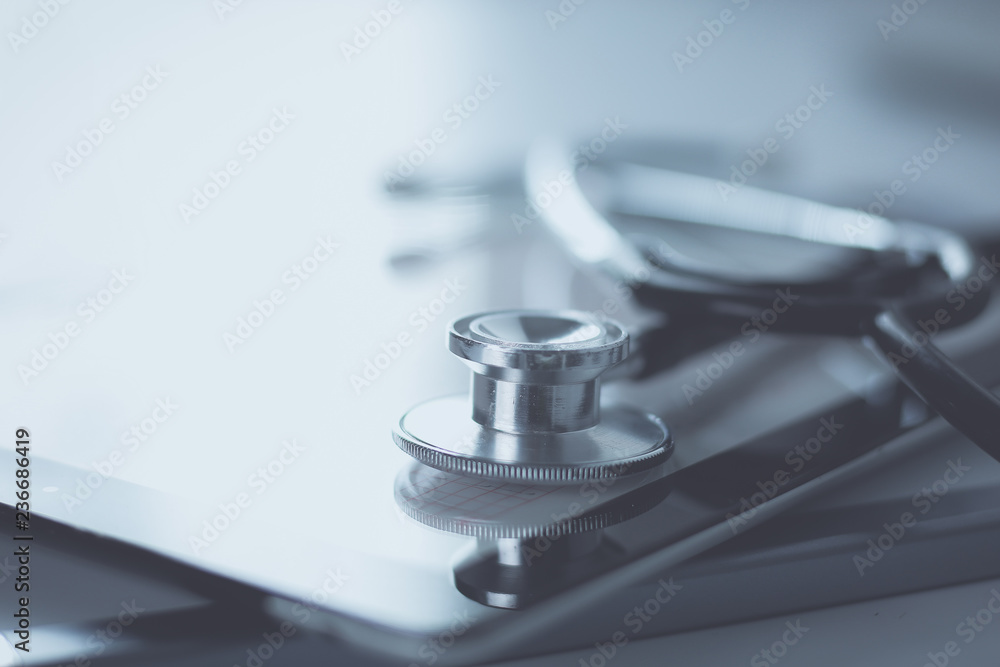 Medical equipment: blue stethoscope and tablet on white background. Medical equipment Medical equipment: blue stethoscope and tablet on white background. Medical equipment