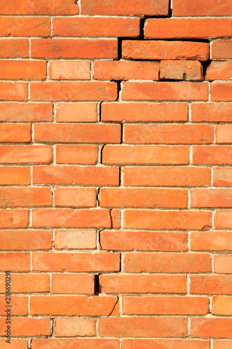 red brick wall and cracks