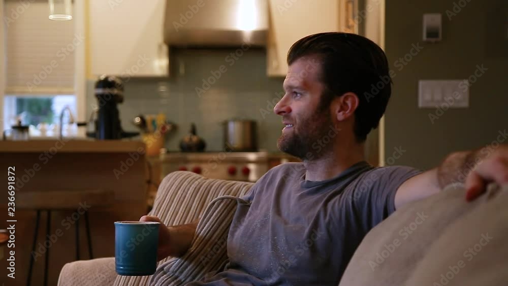 A ruggedly handsome man enjoying his morning while drinking a cup of coffee. A ruggedly handsome man enjoying his morning while drinking a cup of coffee.