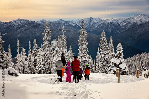family enjoying the frozen and snowy olympic mountains in washington state