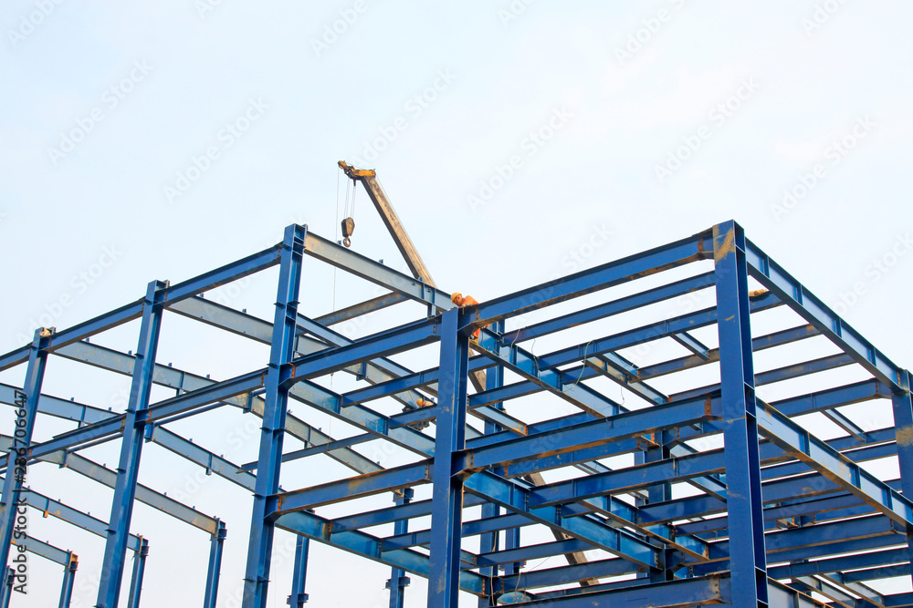 Workers installing steel frame in a factory, China Workers installing steel frame in a factory, China