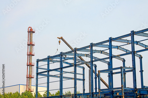 Workers installing steel frame in a factory, China
