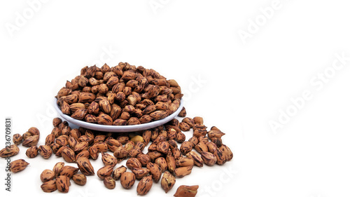 Fototapeta Naklejka Na Ścianę i Meble -  Closeup Shot of Tiger Peanuts in White Ceramic Bowl.  Isolated on White Background with Copy Space for Text.