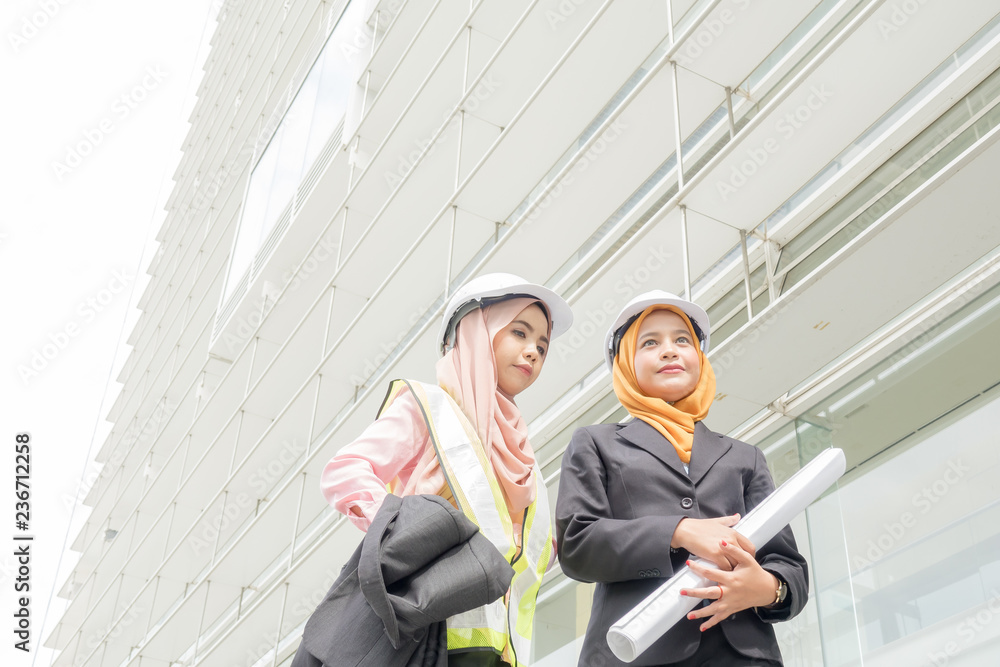 Professional woman engineers are discussing on construction at outdoor. Professional woman engineers are discussing on construction at outdoor.