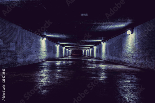 Empty dark tunnel at night with lights